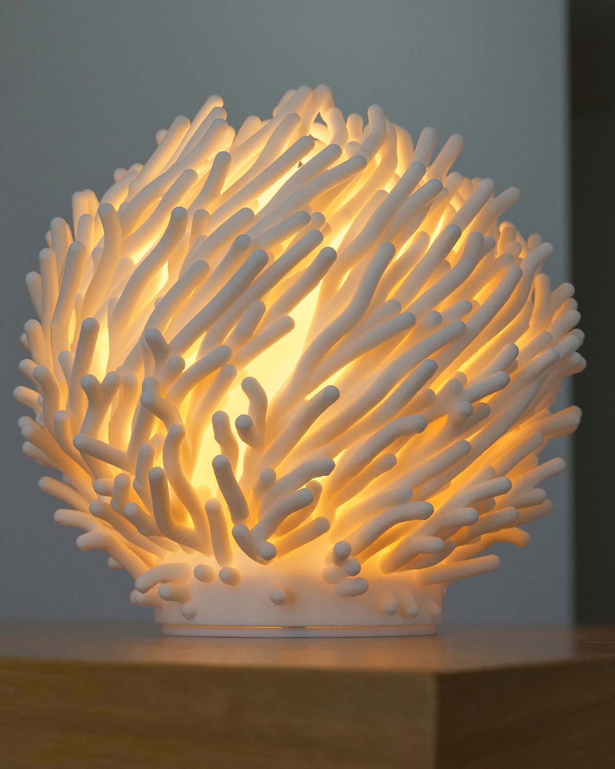Marjan lamp glowing warm white, coral branches lit from within