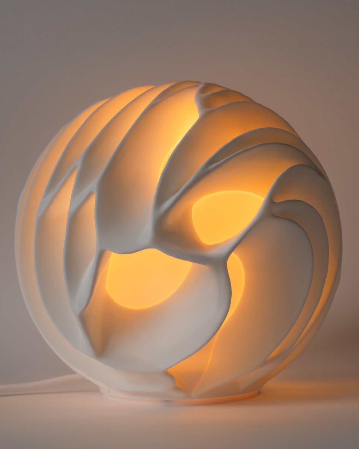 Nawar lamp lit against a soft grey wall